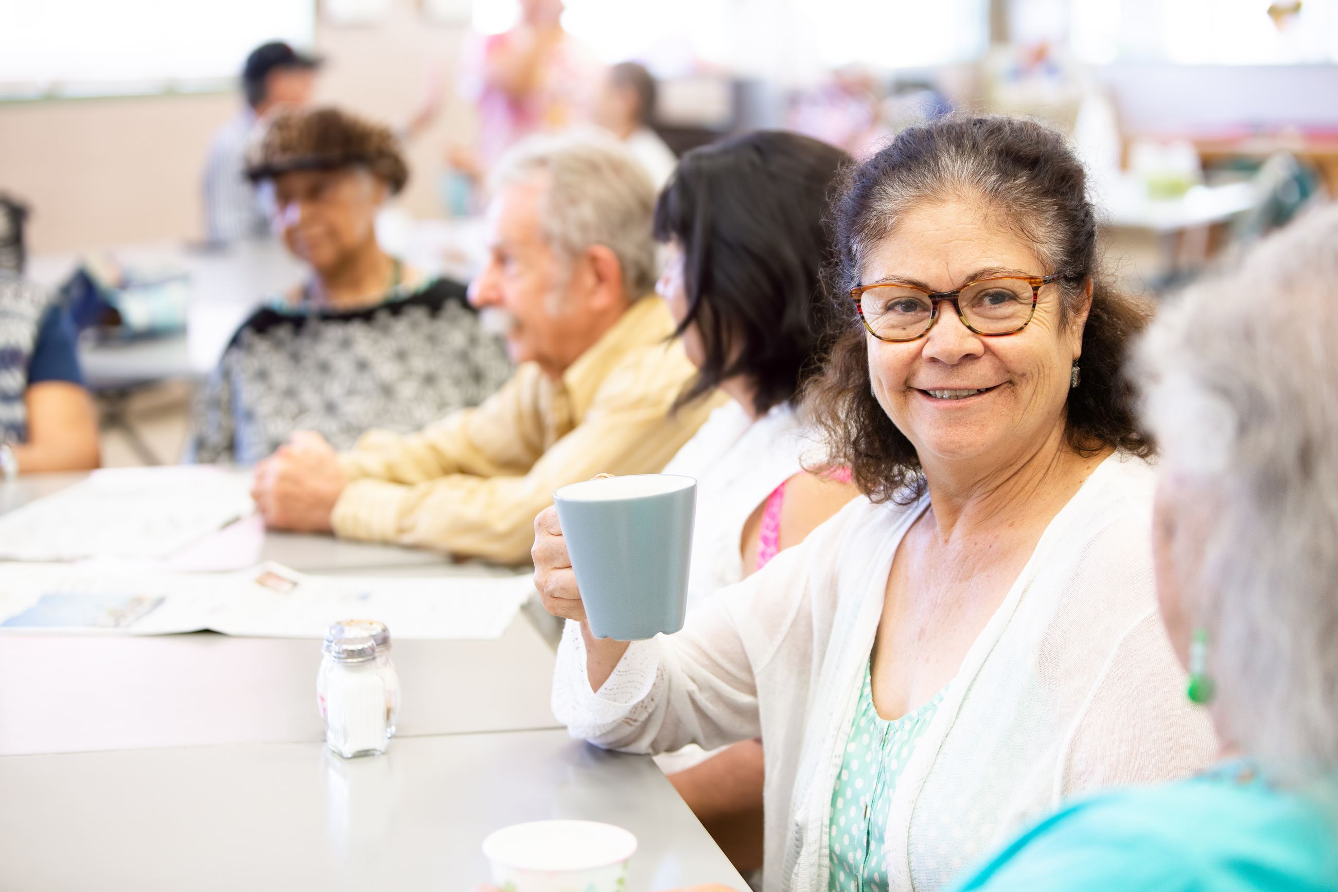 older adults talking and drinking coffee